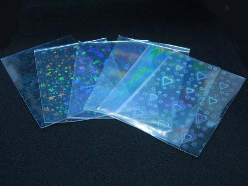 20 vnt. holografinės kortelių įmautės (65×90 mm) – Pokémon, MTG, TCG kortoms, įvairūs dizainai